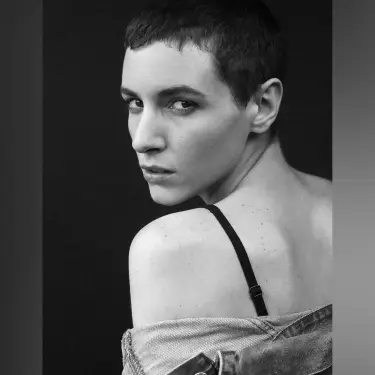 Whitney Masters black and white artistic portrait in three-quarter profile with dramatic studio lighting emphasizing vulnerable expression and contours, photo by 312 Elements Headshot Photography, Chicago, IL headshot photographer