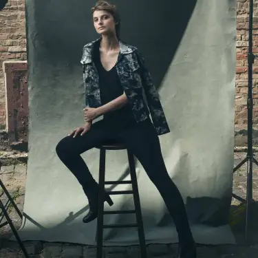 Alicia Kozak confident portrait seated on black stool against industrial brick and concrete studio backdrop in Chicago, photographed by Chicago, IL portrait photographer 312 Elements Headshot Photography