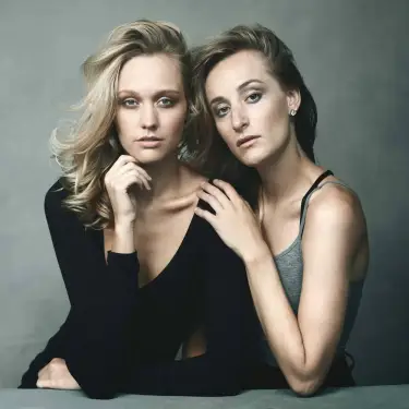 Two women in intimate studio group portrait with contemplative expressions against soft gray background, photographed by Chicago, IL portrait photographer 312 Elements Headshot Photography