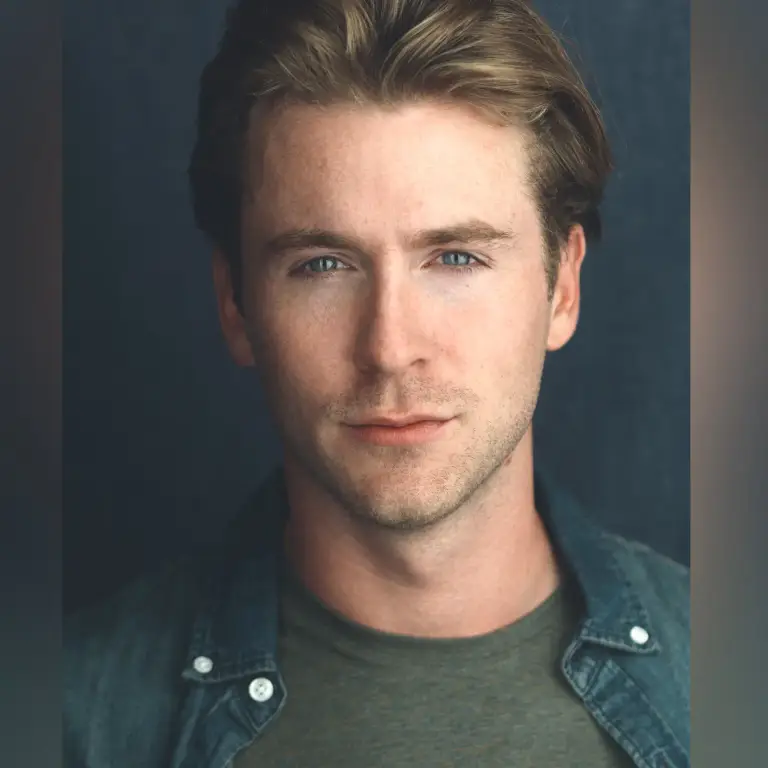 Serious professional headshot of Chris Maher in teal shirt against dark blue background with contemplative direct gaze, photo by 312 Elements Headshot Photography, Chicago, IL headshot photographer