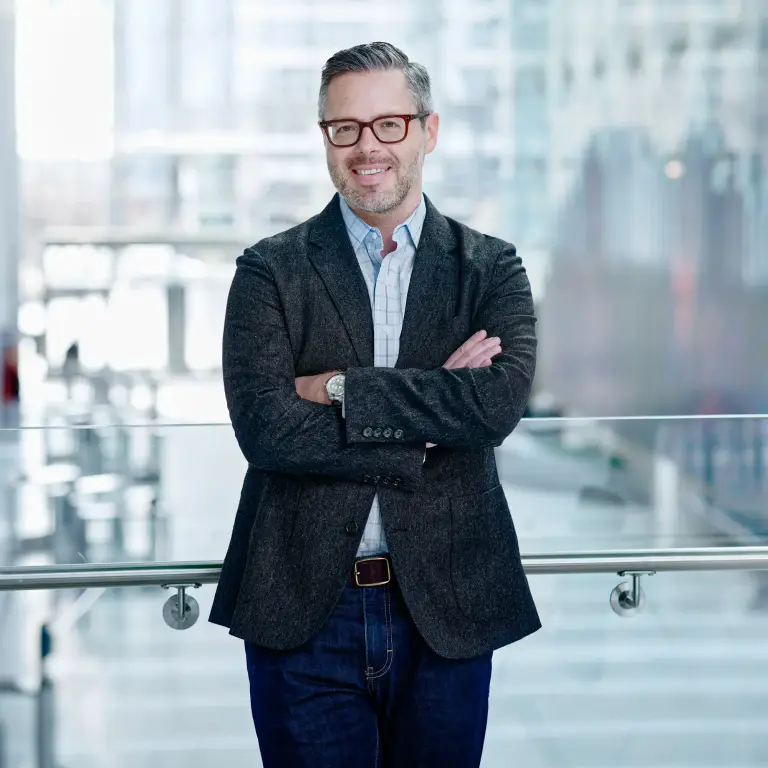 Steven Schwab in charcoal blazer with burgundy tie, office window backdrop, professional headshot in Chicago, captured by 312 Elements Headshot Photography, headshot photographer in Chicago, IL