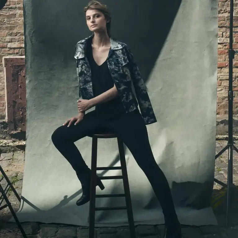 Alicia Kozak confident portrait seated on black stool against industrial brick and concrete studio backdrop in Chicago, photographed by Chicago, IL portrait photographer 312 Elements Headshot Photography
