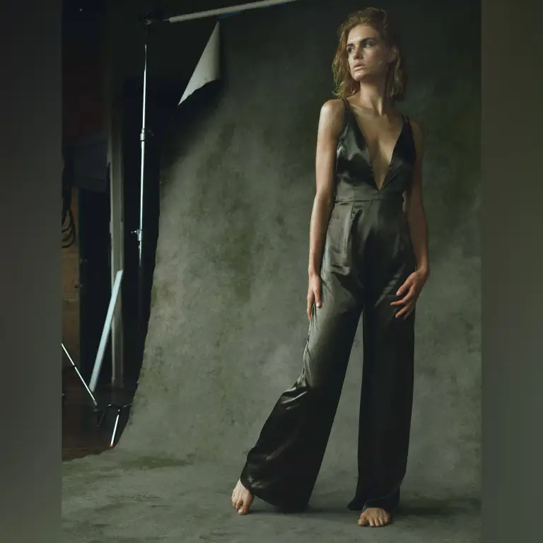 Professional fashion portrait of Cole Knight in black and white color-block dress against textured gray-green studio backdrop, photographed by Chicago, IL portrait photographer 312 Elements Headshot Photography