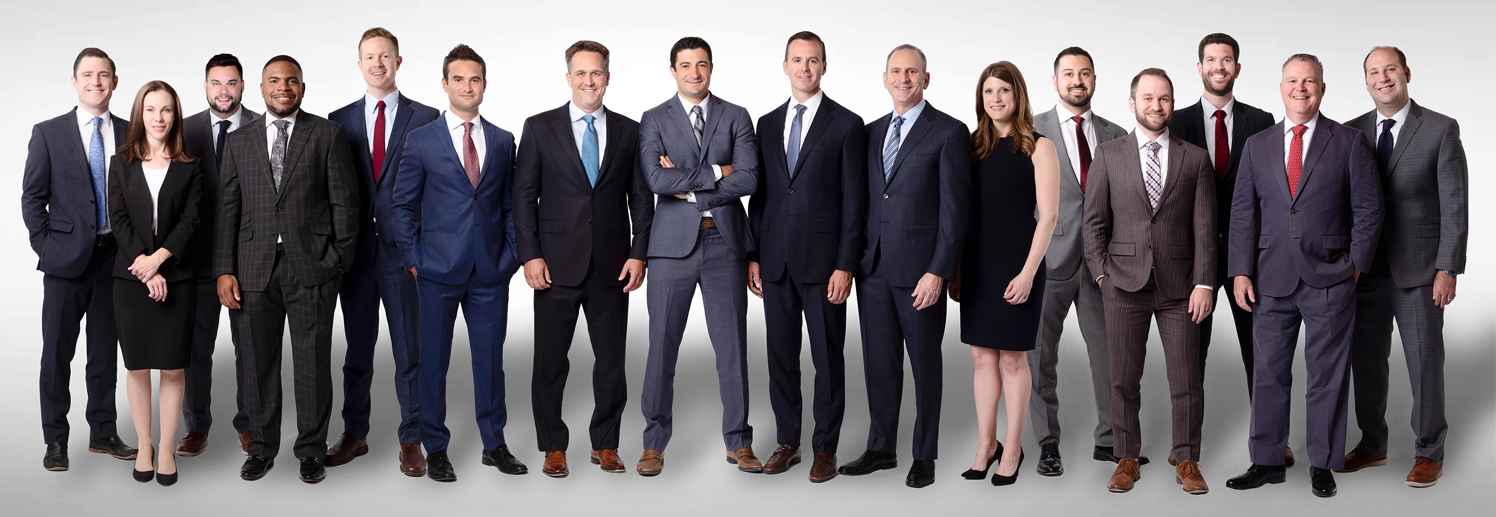 Professional group headshots of the law firm team, highlighting expertise and dedication, set against a bright white background.