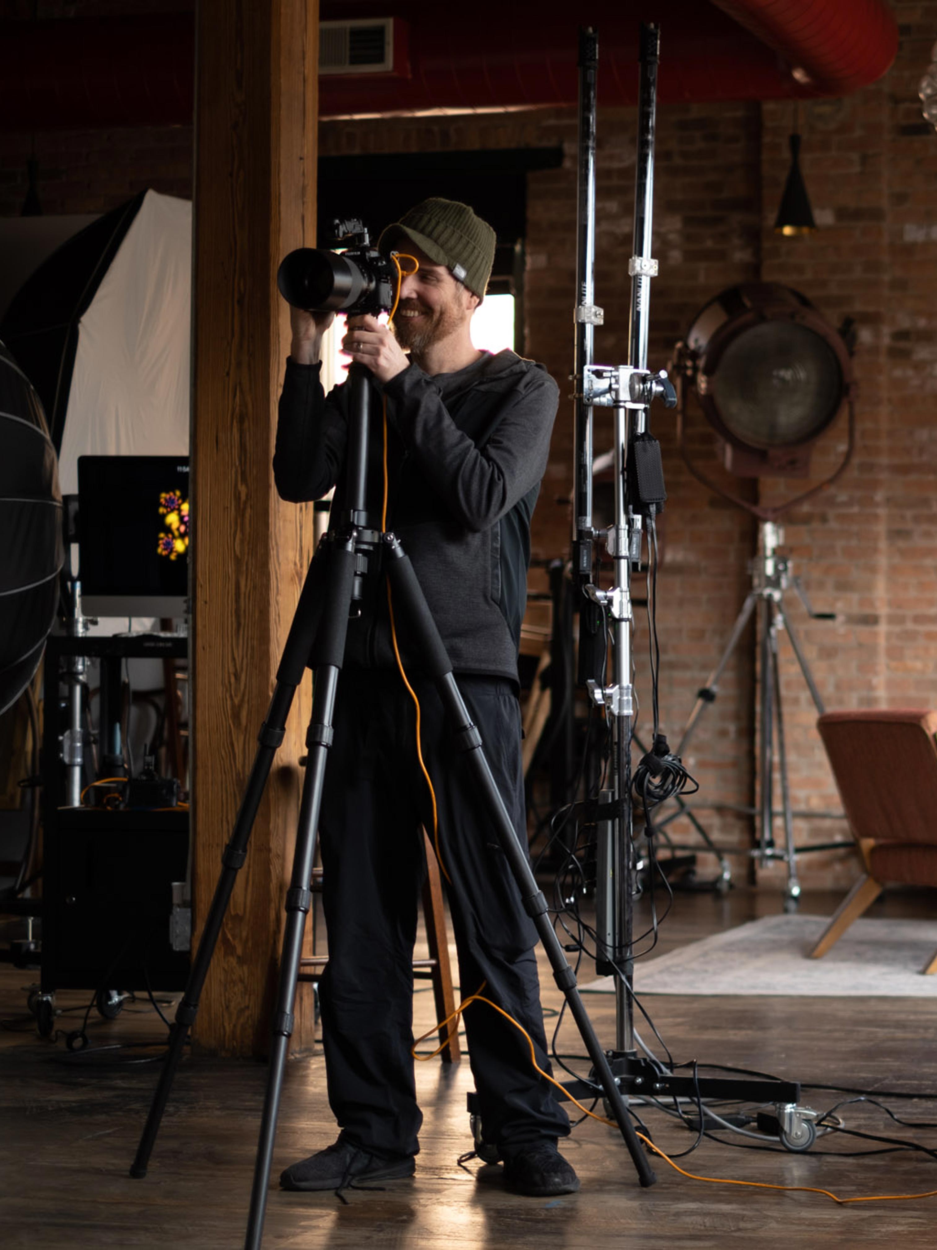 Behind the scenes action shot of portrait photographer Michael Schacht during a photoshoot in his west loop studio.