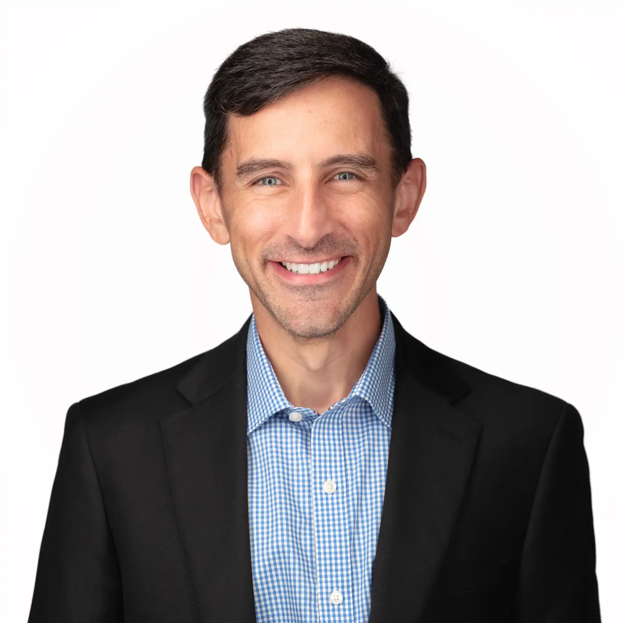 A well-dressed professional smiling confidently for a business headshot, showcasing a friendly demeanor and appropriate attire.