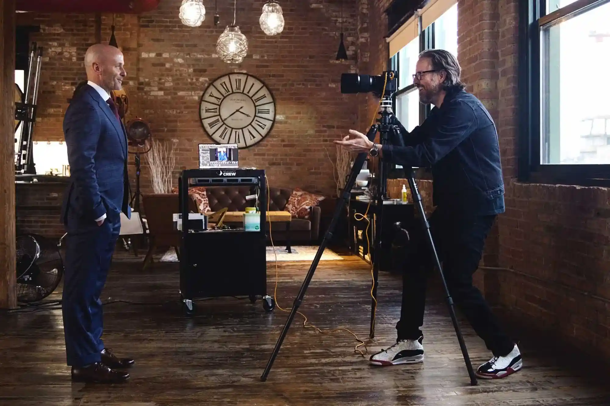 Behind the scenes shot of business man being photographed by celebrity portrait and headshot photographer Michael Schacht at his chic west loop headshot studio