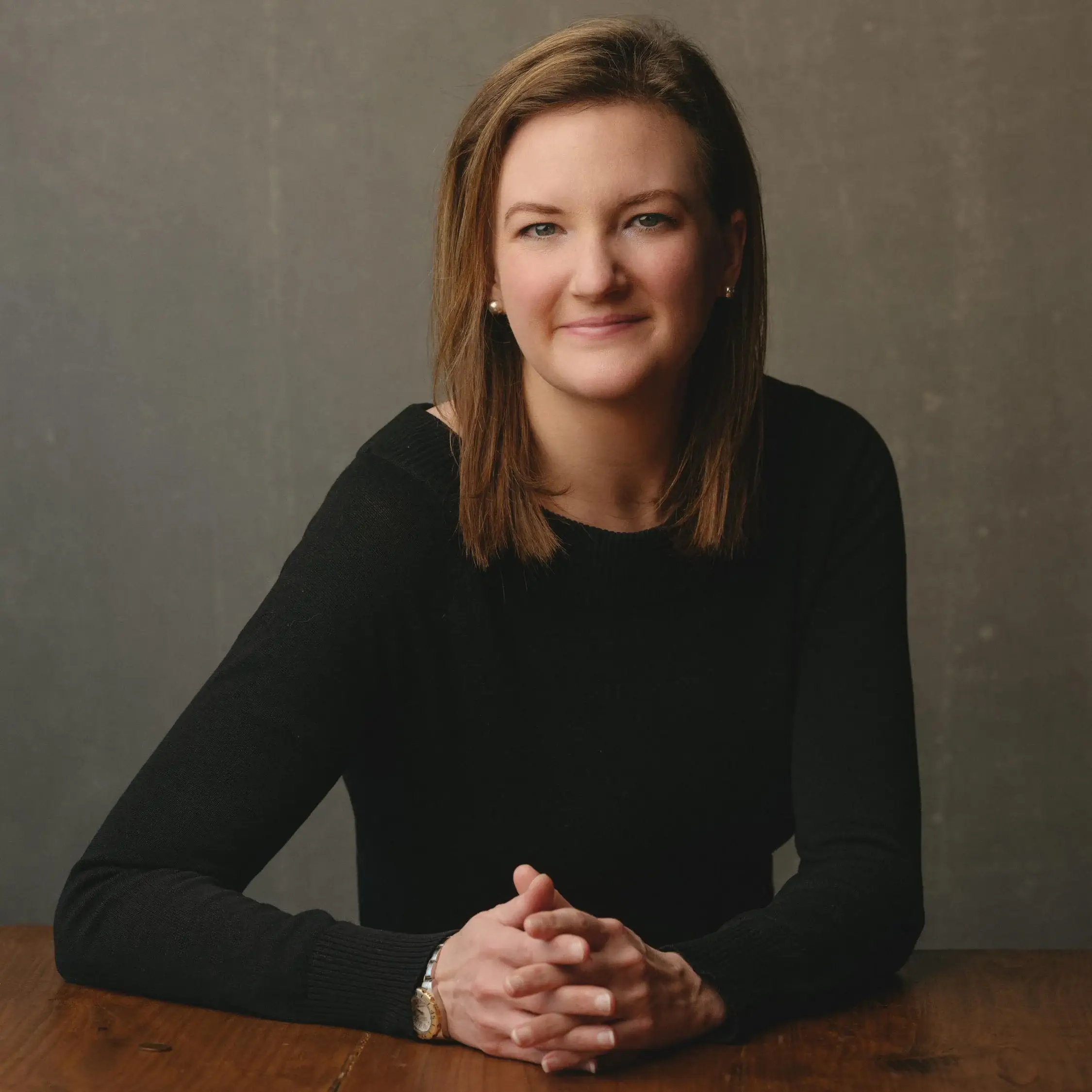 Vanity Fair-inspired corporate portrait of a professional individual posing confidently against a hand-painted backdrop, showcasing a stylish and artistic flair